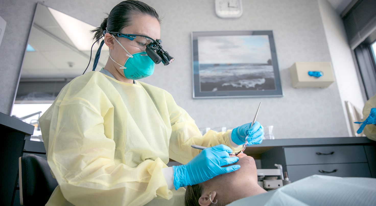 Doctor guiding patient on brushing teeth